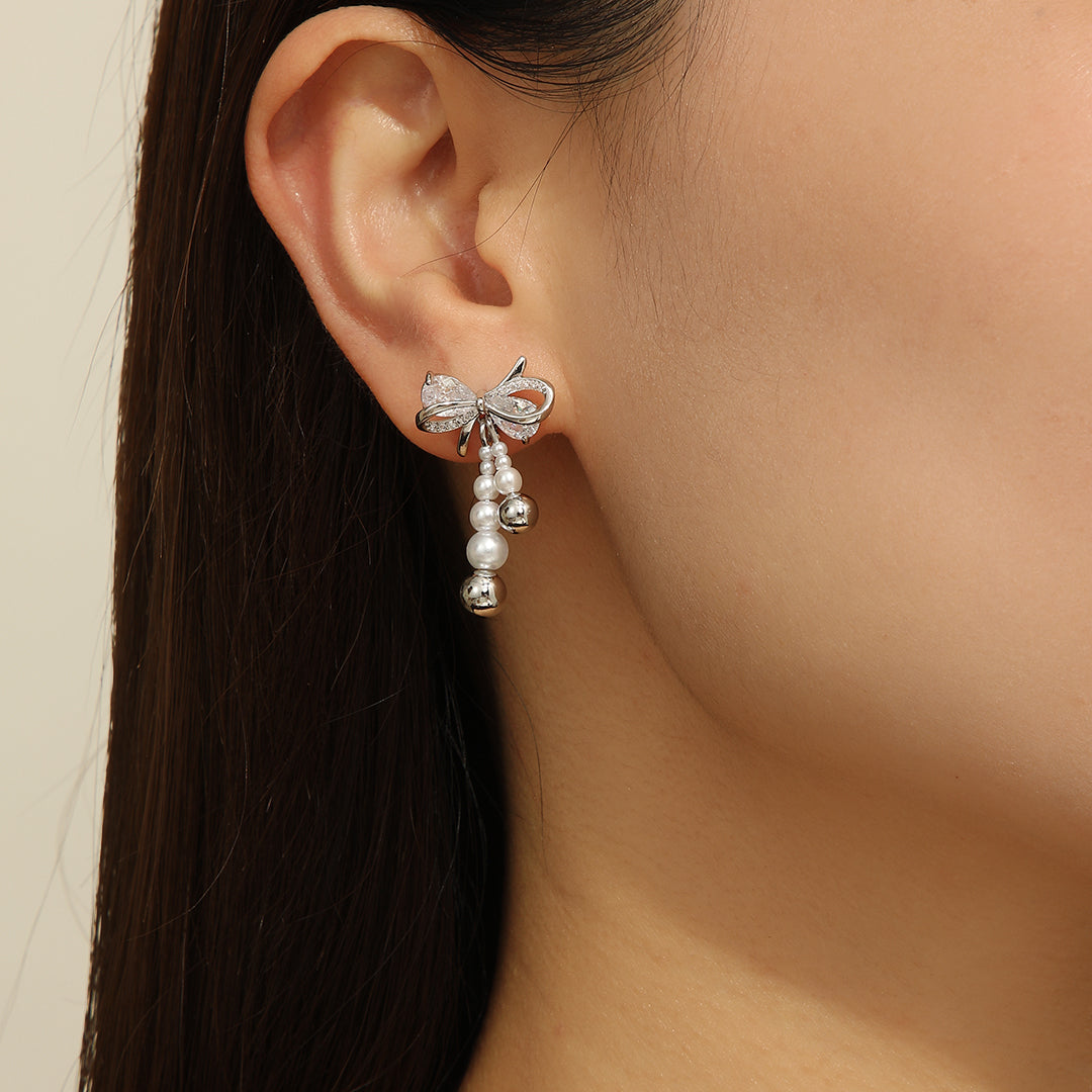 “Pearlescent Silver Bow Earrings - Reet Pehal