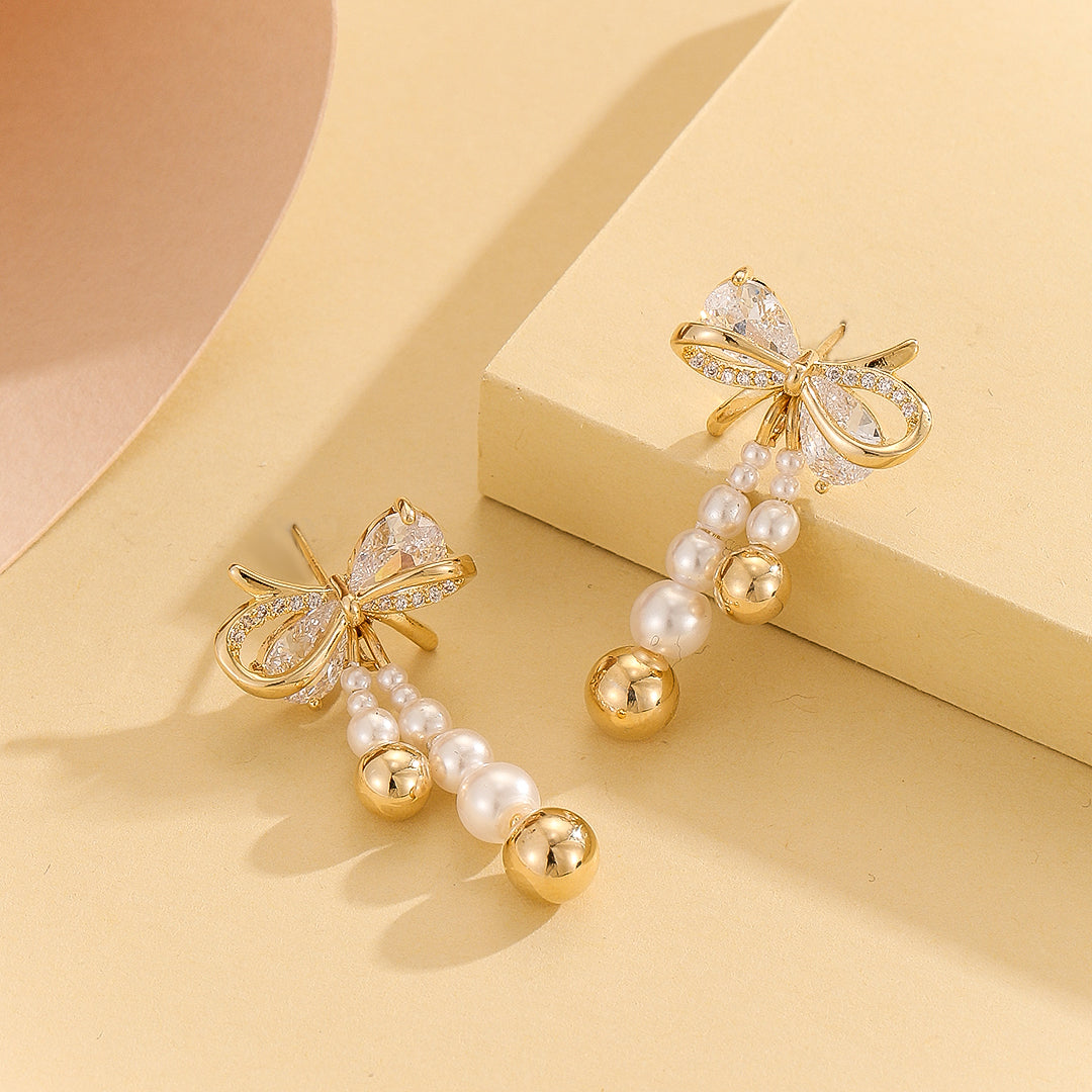 Pearlescent Golden Bow Earrings - Reet Pehal