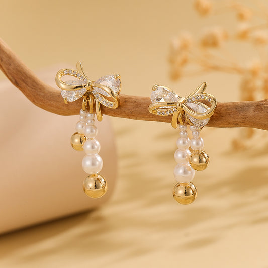 Pearlescent Golden Bow Earrings - Reet Pehal